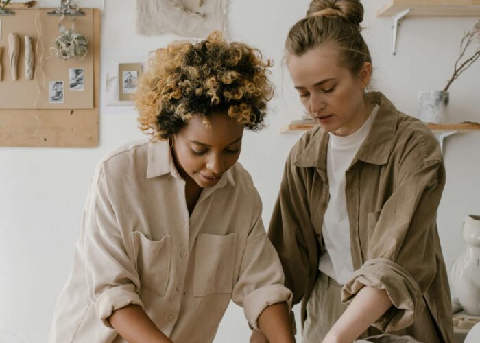 pexels-photo-6694304-6694304 Two women sculpting clay in a pottery workshop, showcasing creativity and craftsmanship.